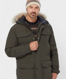 Man wearing a black coat with a fur hood.