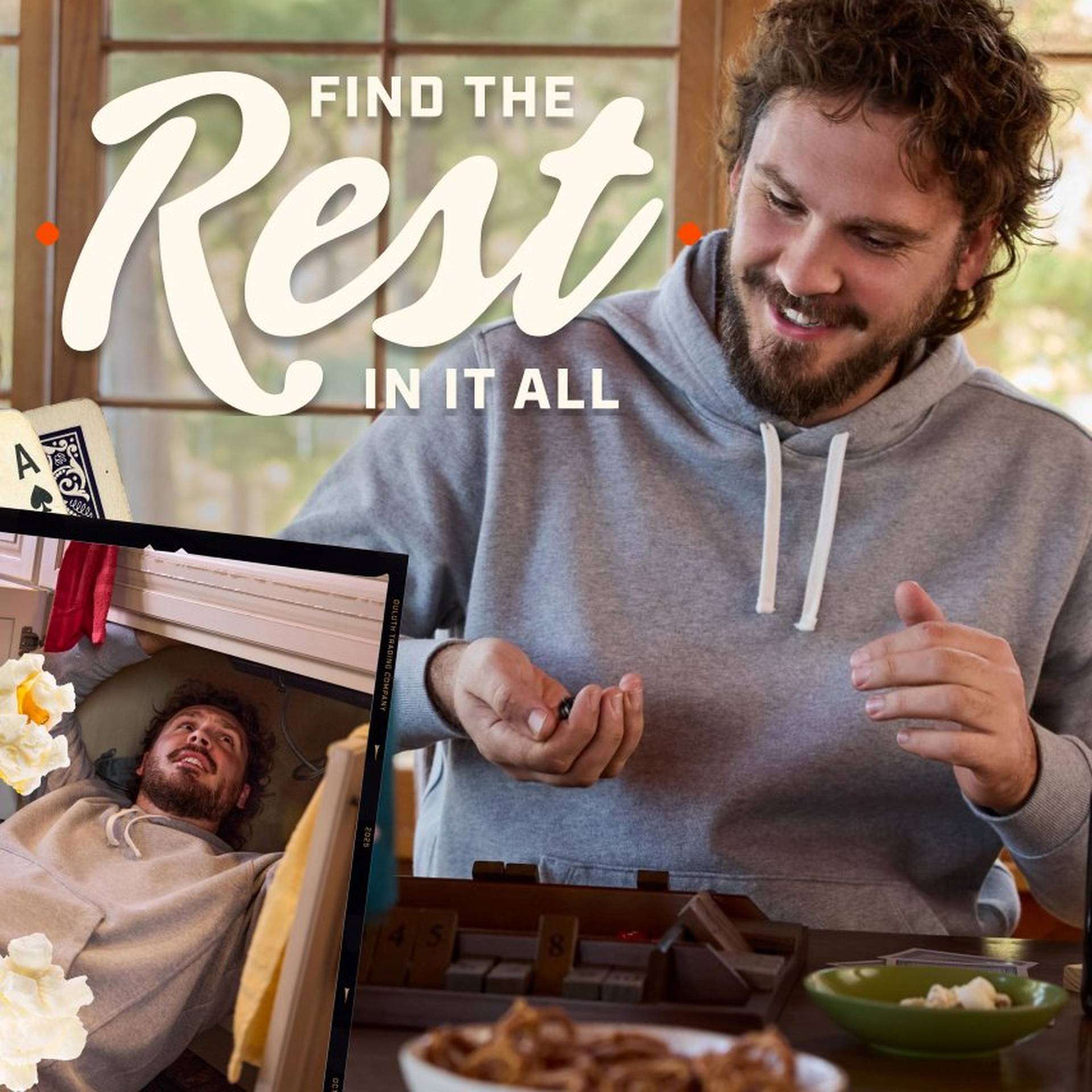 Man wearing a grey hooded sweatshirt eating snacks.