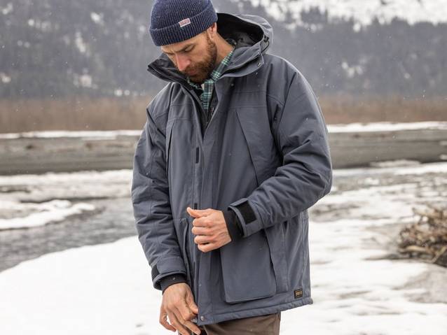  Man wearing a navy blue winter jacket and navy blue fold over beanie.