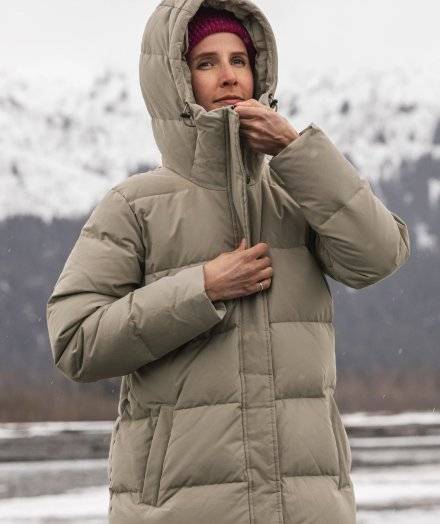 Woman wearing a tan insulated puffer coat.