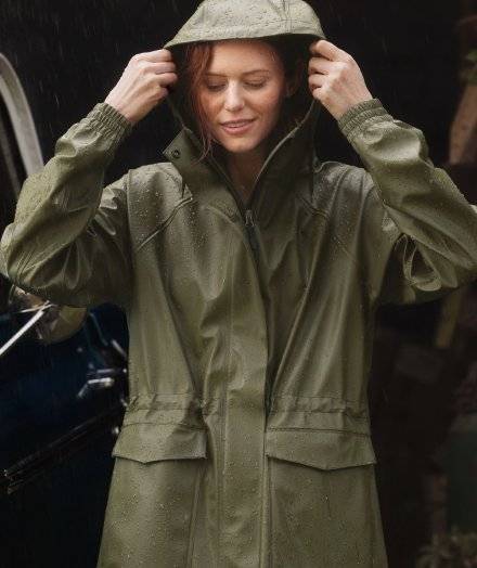 Woman wearing a green rain jacket.