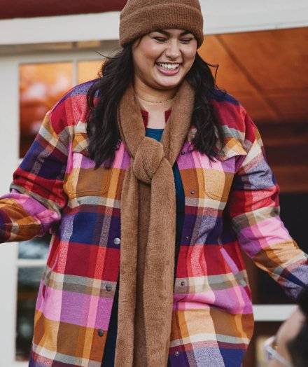 Woman wearing a flannel shirt jac.