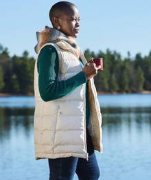 Woman wearing a long white vest.