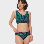 Woman wearing floral patterned bra and underwear.