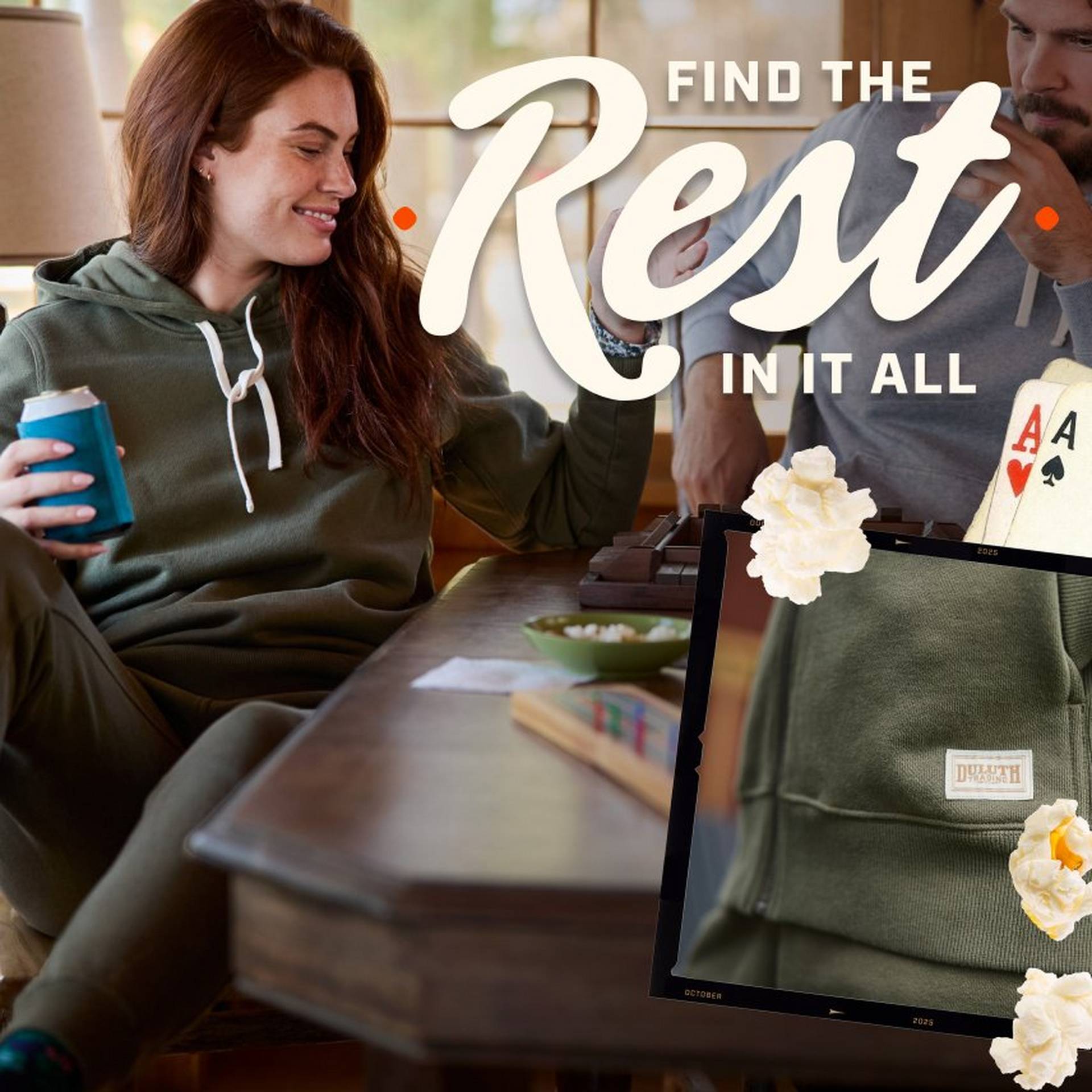 Woman wearing an olive green hoodie, playing a boardgame.