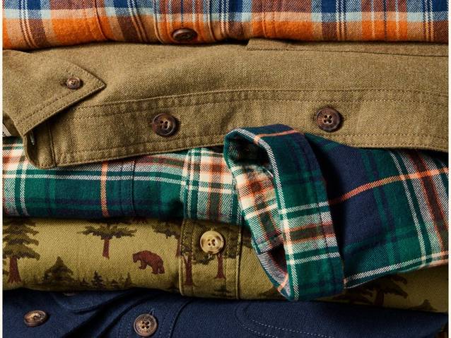 Folded flannels stacked in a pile.