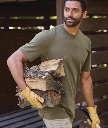 Man wearing green t-shirt, carrying logs.