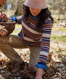 Woman wearing a striped sweater.