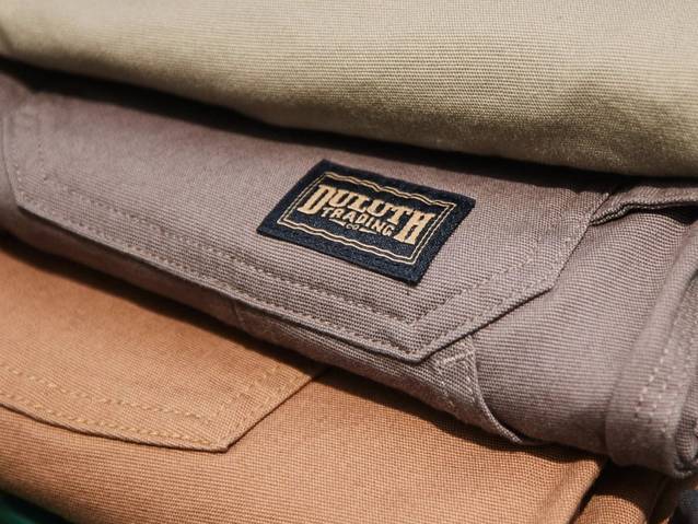 Men's work pants folded and stacked.