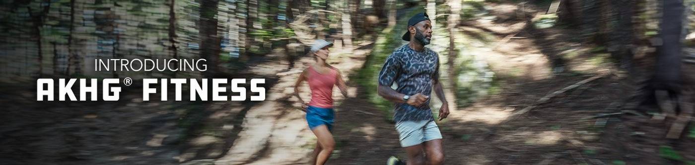 Man and woman trail running in a forest