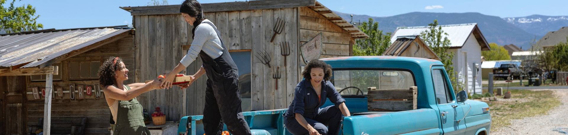 Three women wearing overalls