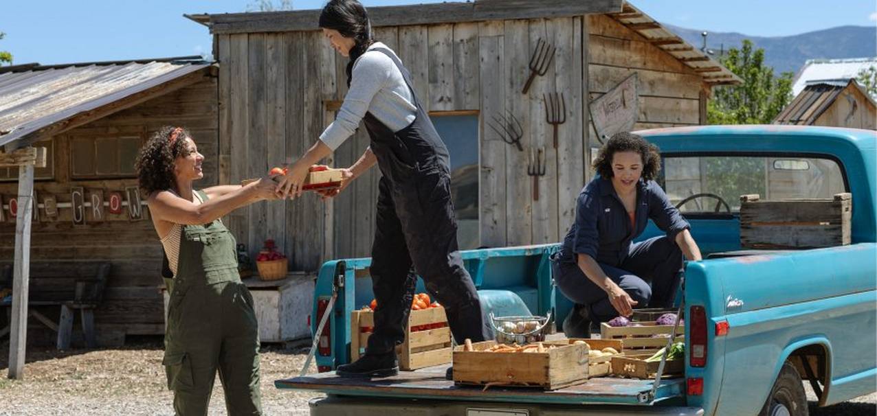 Three women wearing overalls.