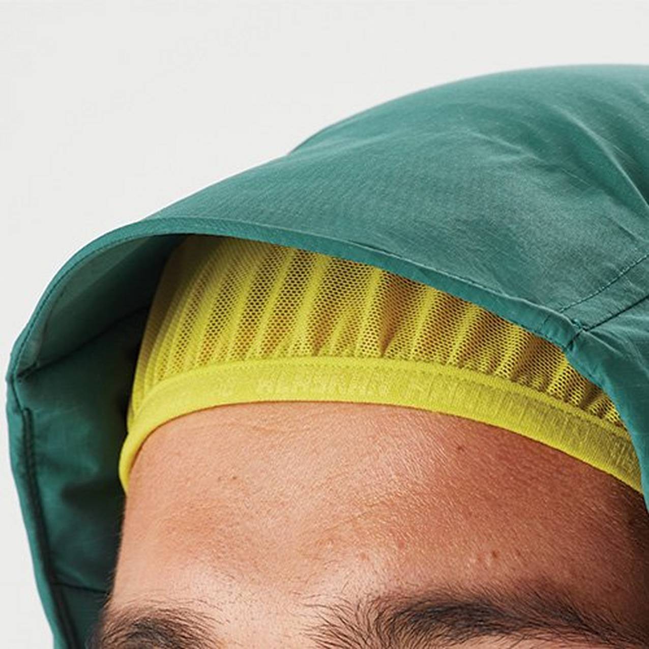 Close up of the hood of a jacket with an elastic hood liner holding the hood tight to the head