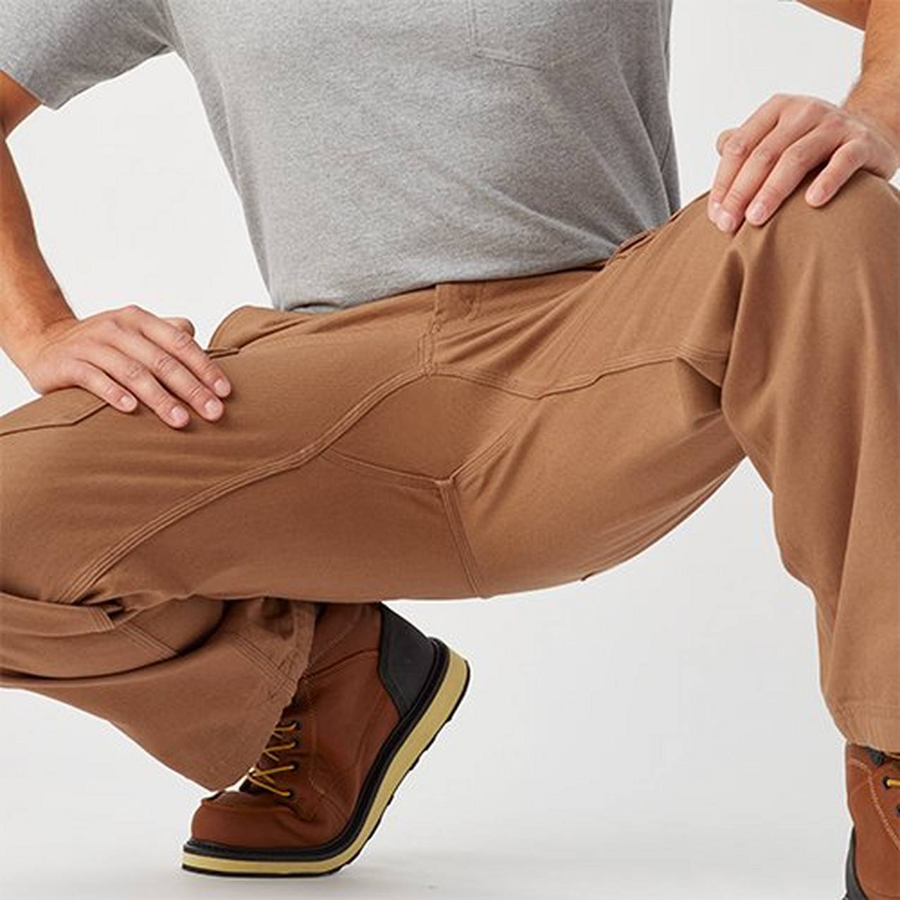 Man crouching in fire hose pants