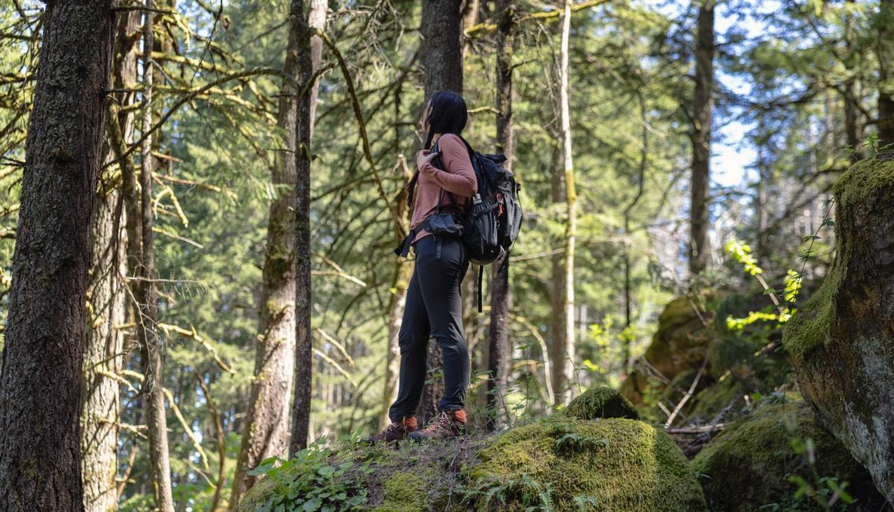 Woman hiking through woods