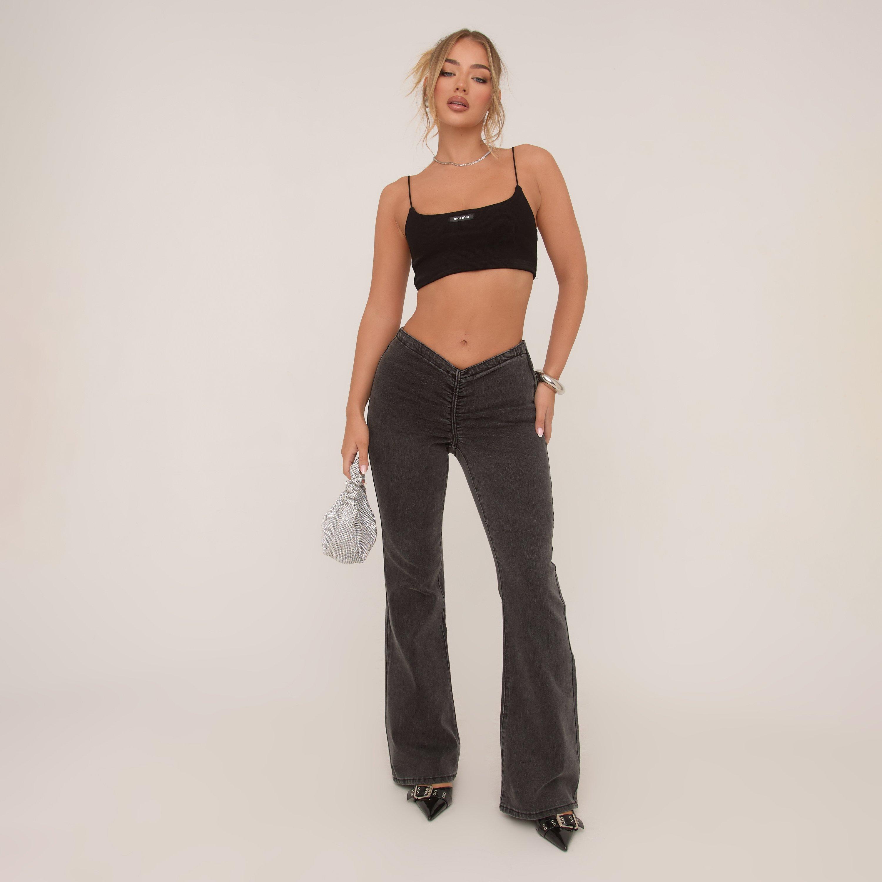 Image of Dipped Waist Ruched Front Flared Jeans In Black Washed Denim, Women's