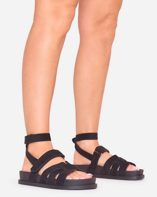 Roller Cut Out Wrap Around Velcro Strap Flat Sandal In Black Faux Suede