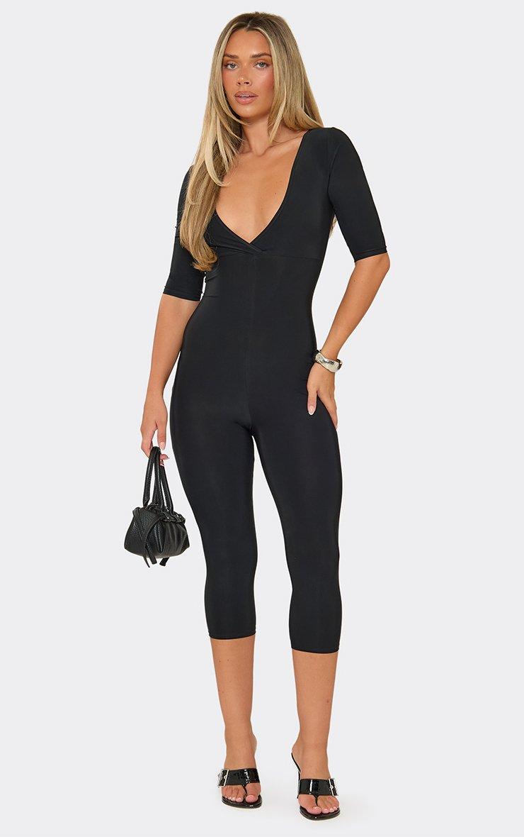 Three Quarter Sleeve Plunge Front Capri Jumpsuit In Black.
