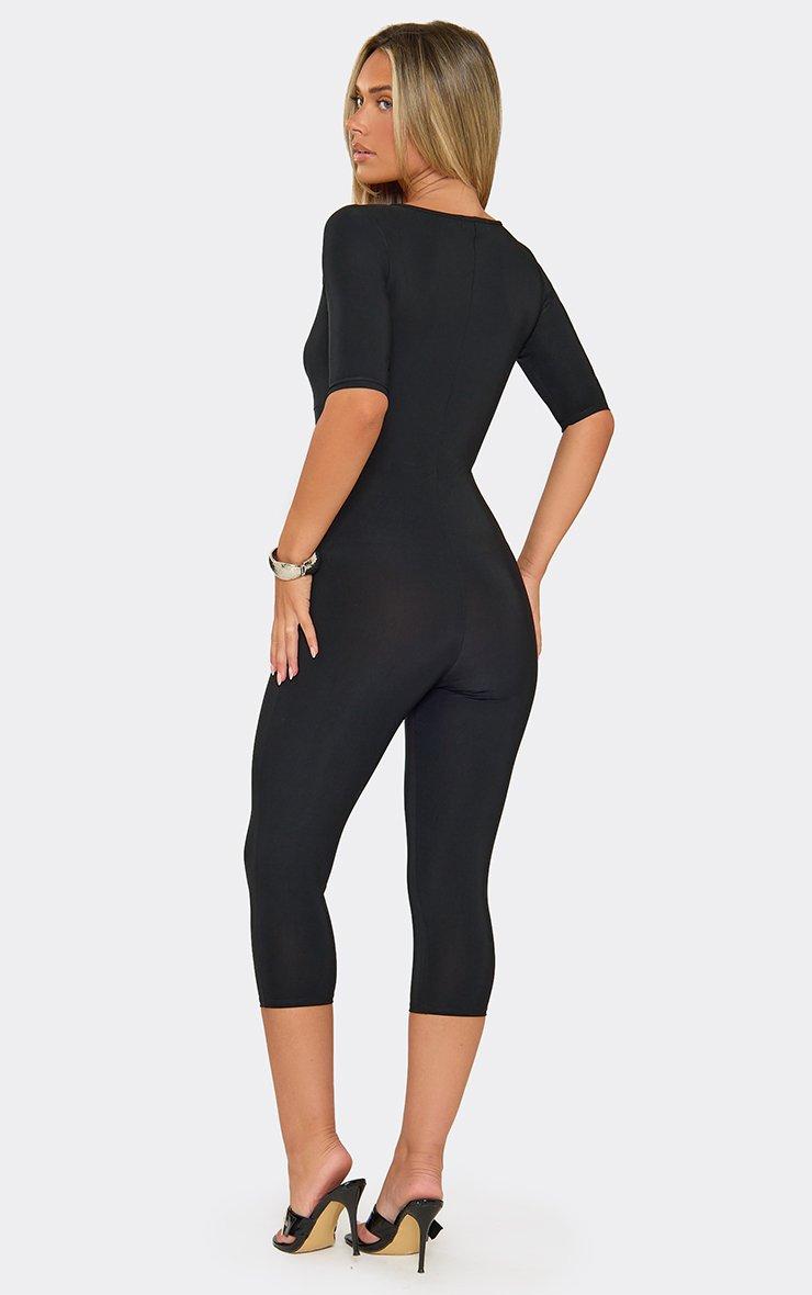 Three Quarter Sleeve Plunge Front Capri Jumpsuit In Black.