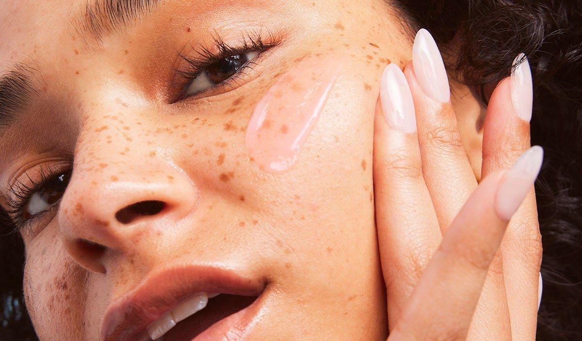 Model Applying Niacinamide Serum To Skin