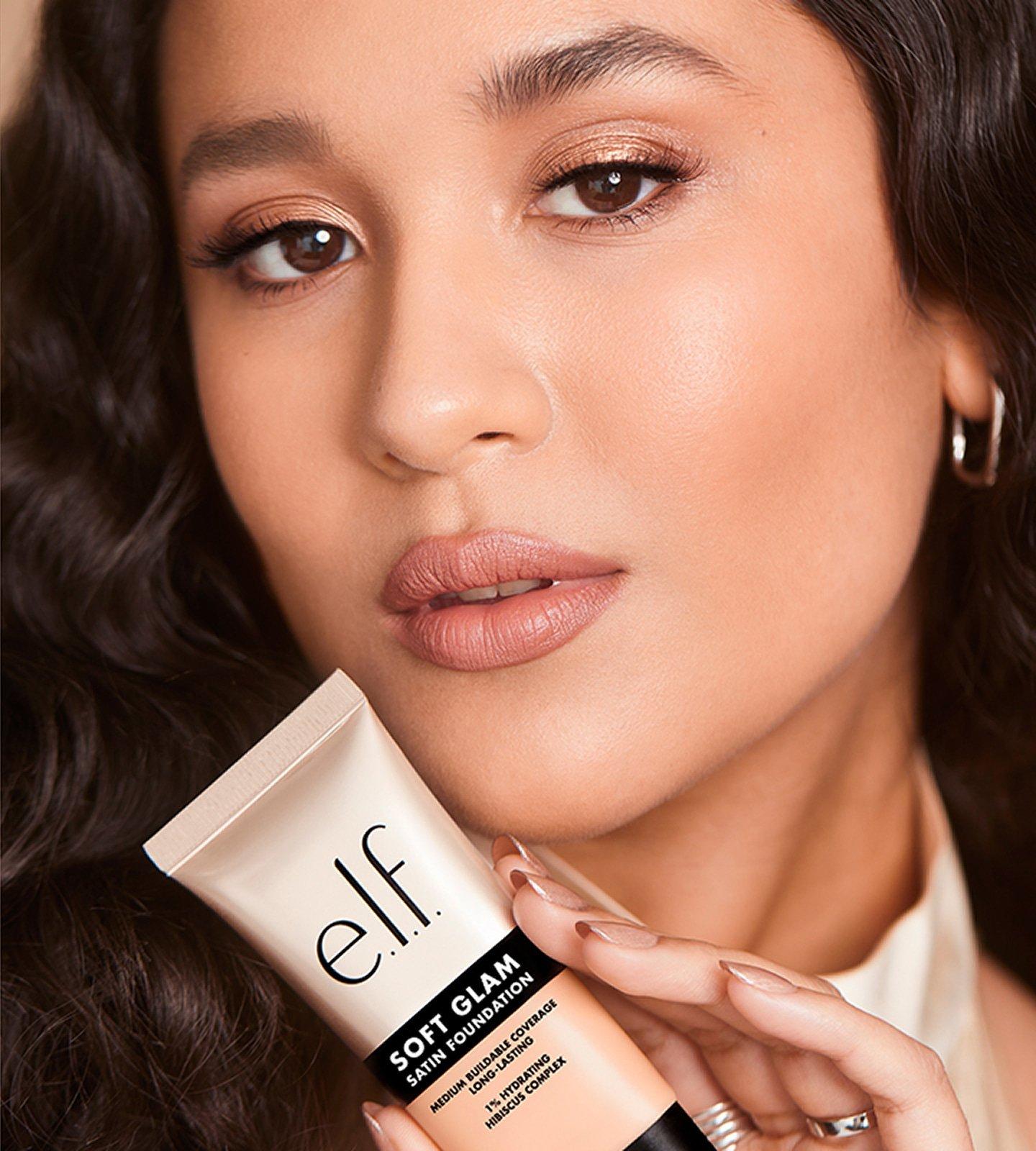 model holding e.l.f. Soft Glam Satin Foundation