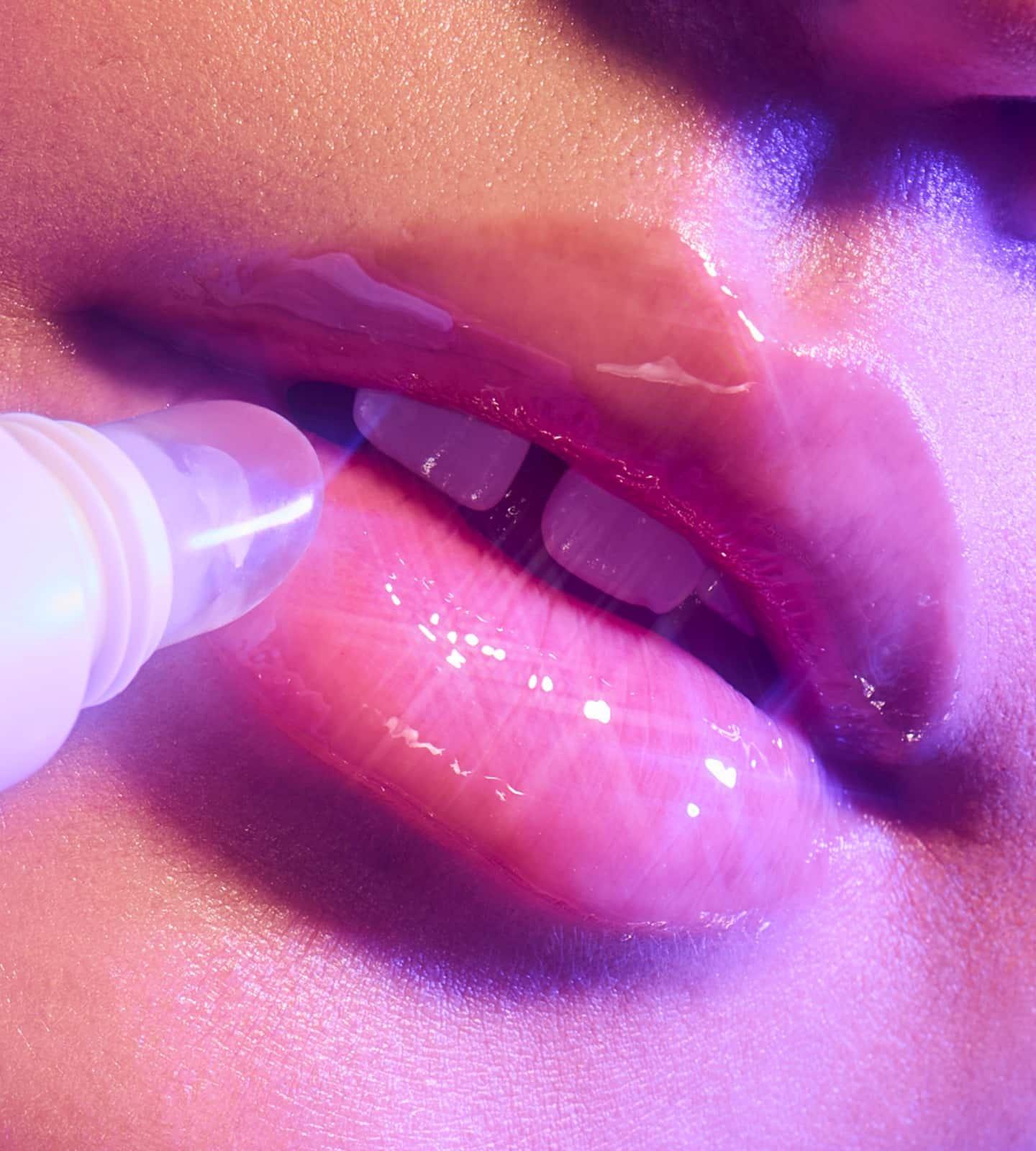 Model applying e.l.f. Glow Reviver Melting Lip Balm