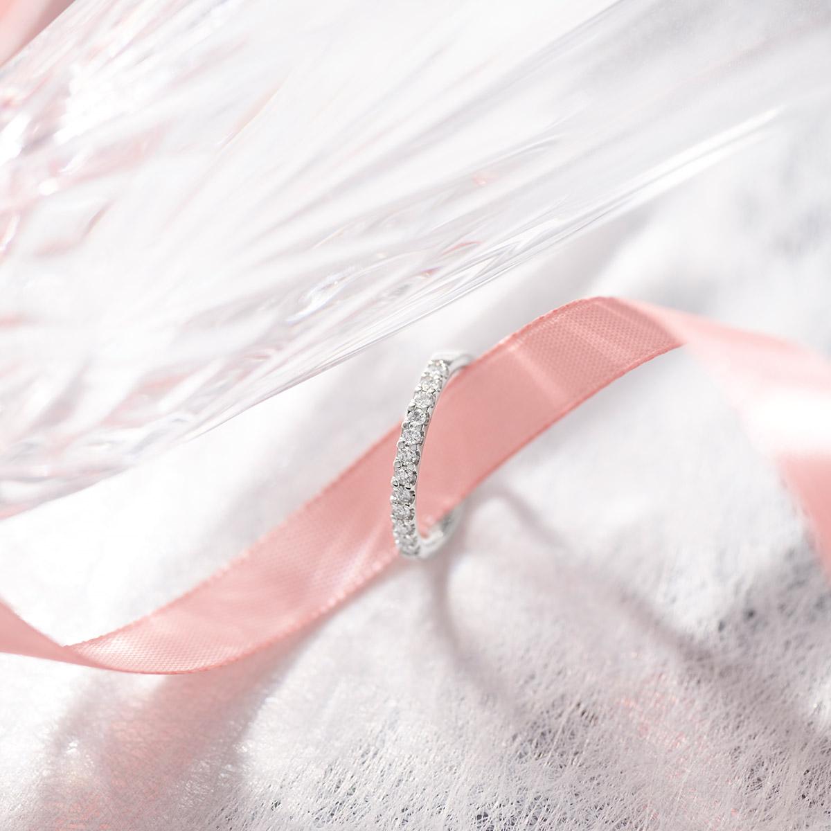 Platinum diamond ring on pink ribbon