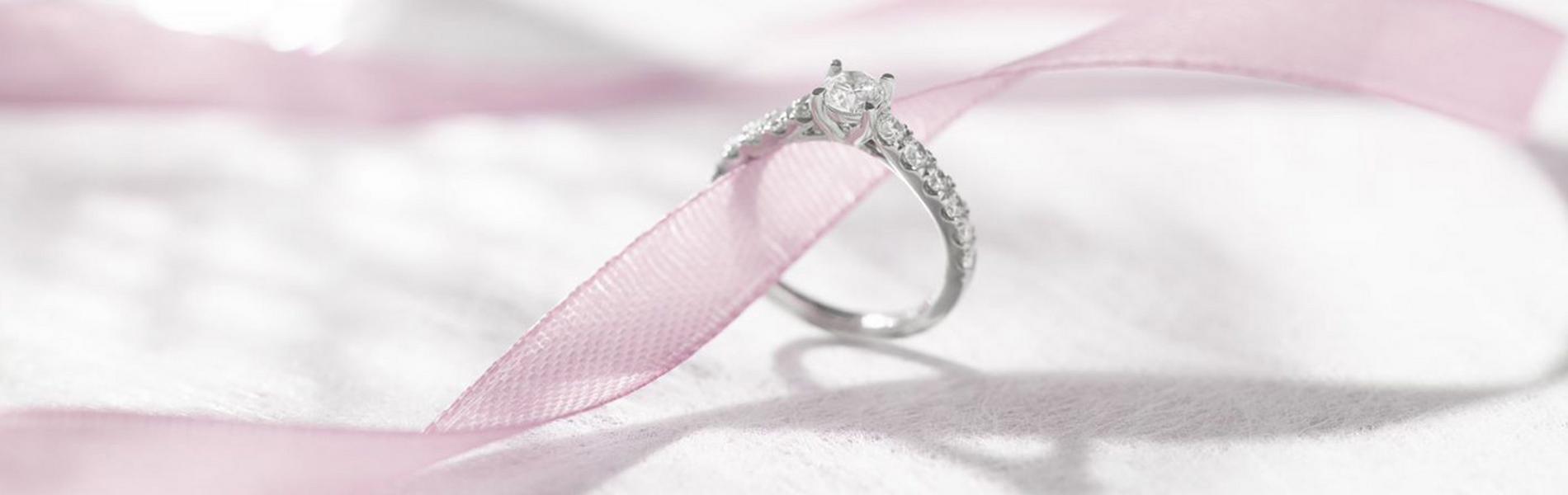 diamond engagement ring on pink ribbon