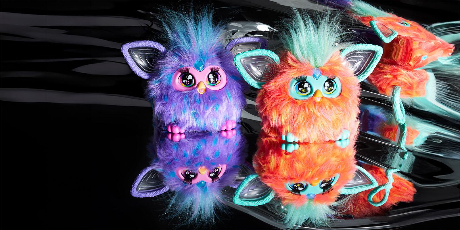 Two colourful furby toys