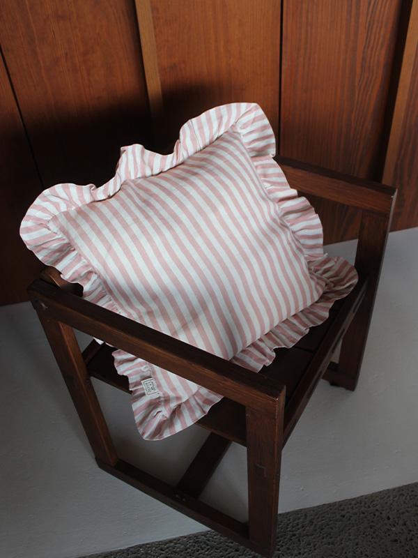 pink and white striped cushion on a chair