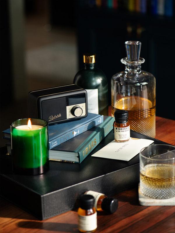 close up of desk with an assortment of books and candles