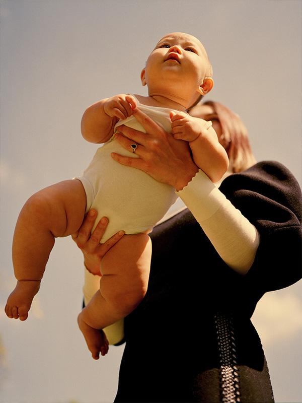 Baby being held in the air by woman