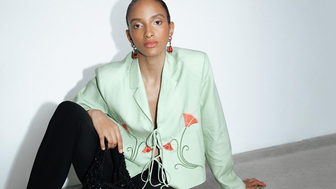 A woman wearing a mint occasion blazer