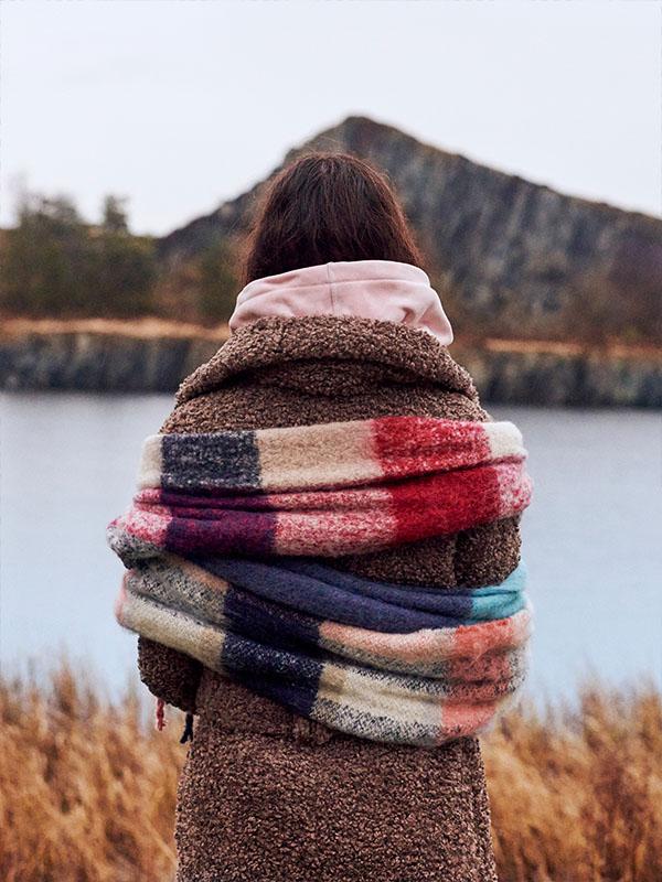 woman standing in front of a lake