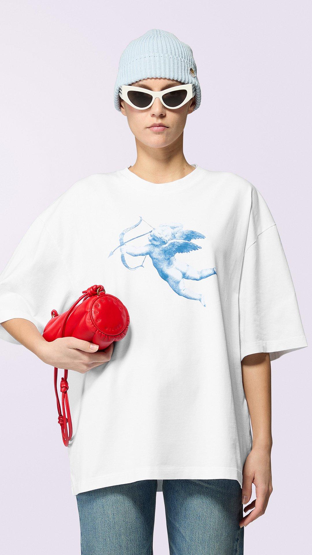 Model wears the Unisex Cupid Graphic T-Shirt in white.