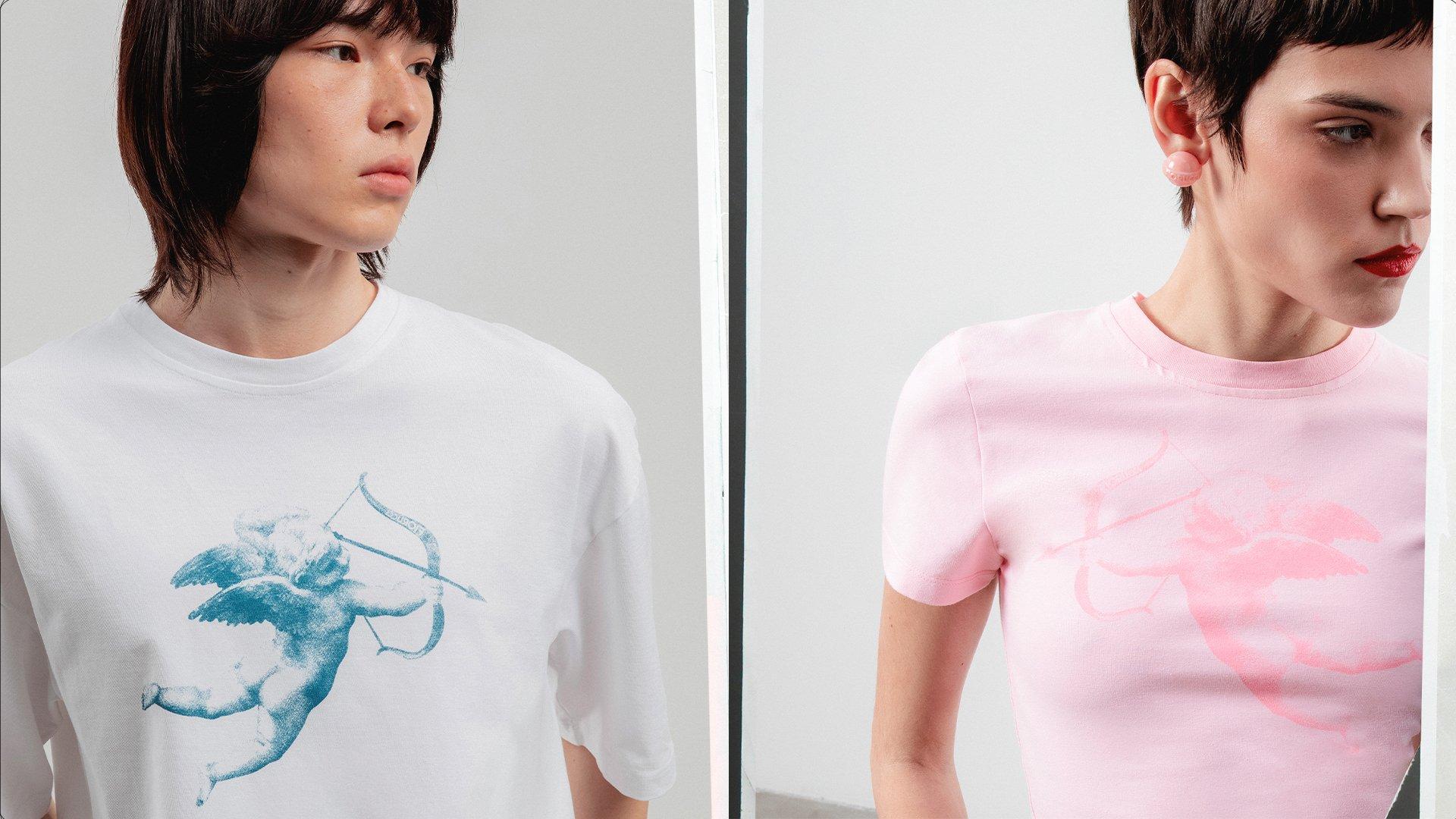 Male model wears Unisex Cupid Graphic T-Shirt in white and female model Cupid Graphic Baby T-Shirt in pink.