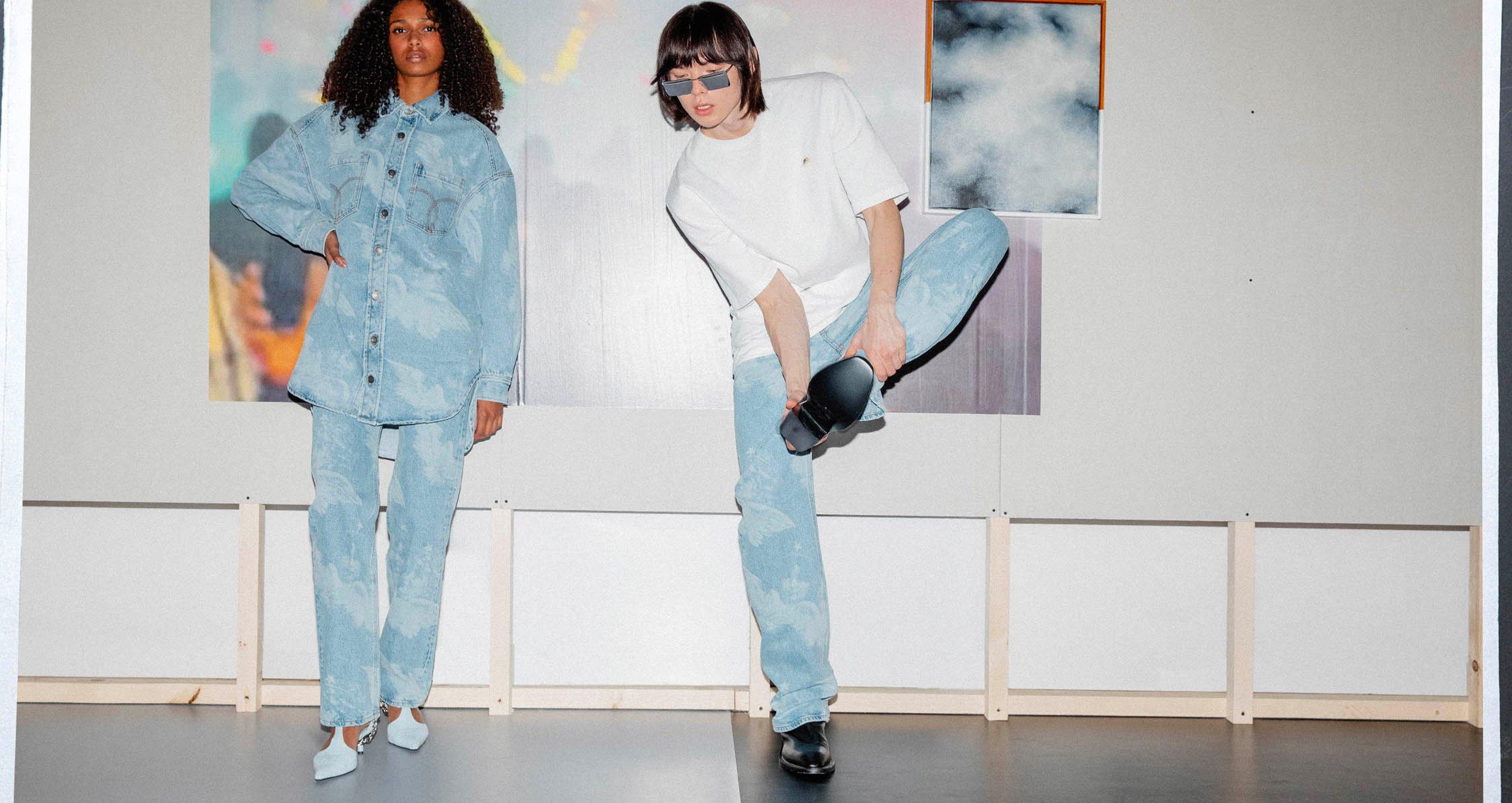 Models wear the Angels Denim Shirt Dress in light blue and the Unisex Angels Straight Fit Jeans in light blue.