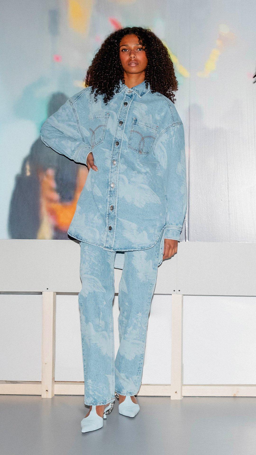 Model wears the Angels Denim Shirt Dress in light blue and the Unisex Angels Straight Fit Jeans in light blue.