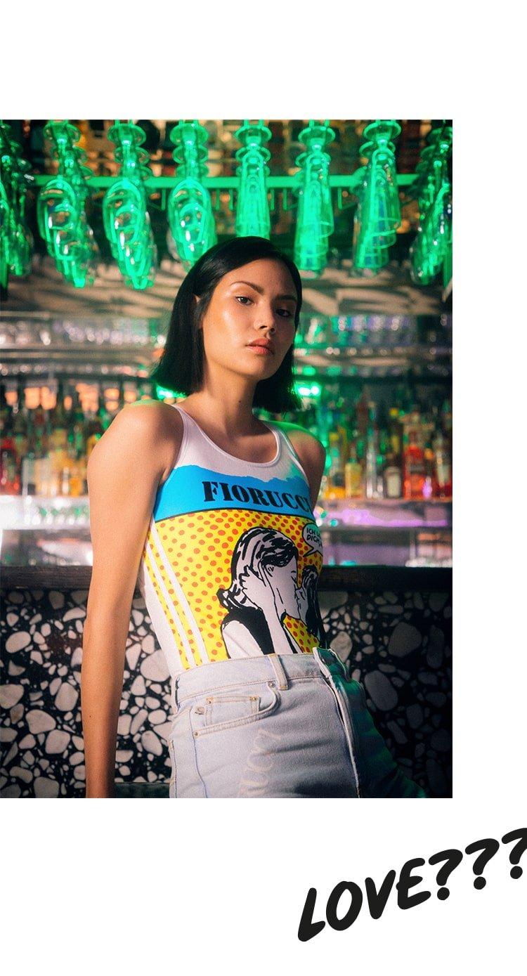 Model wearing the Adidas x Fiorucci Love Print Bodysuit in white.