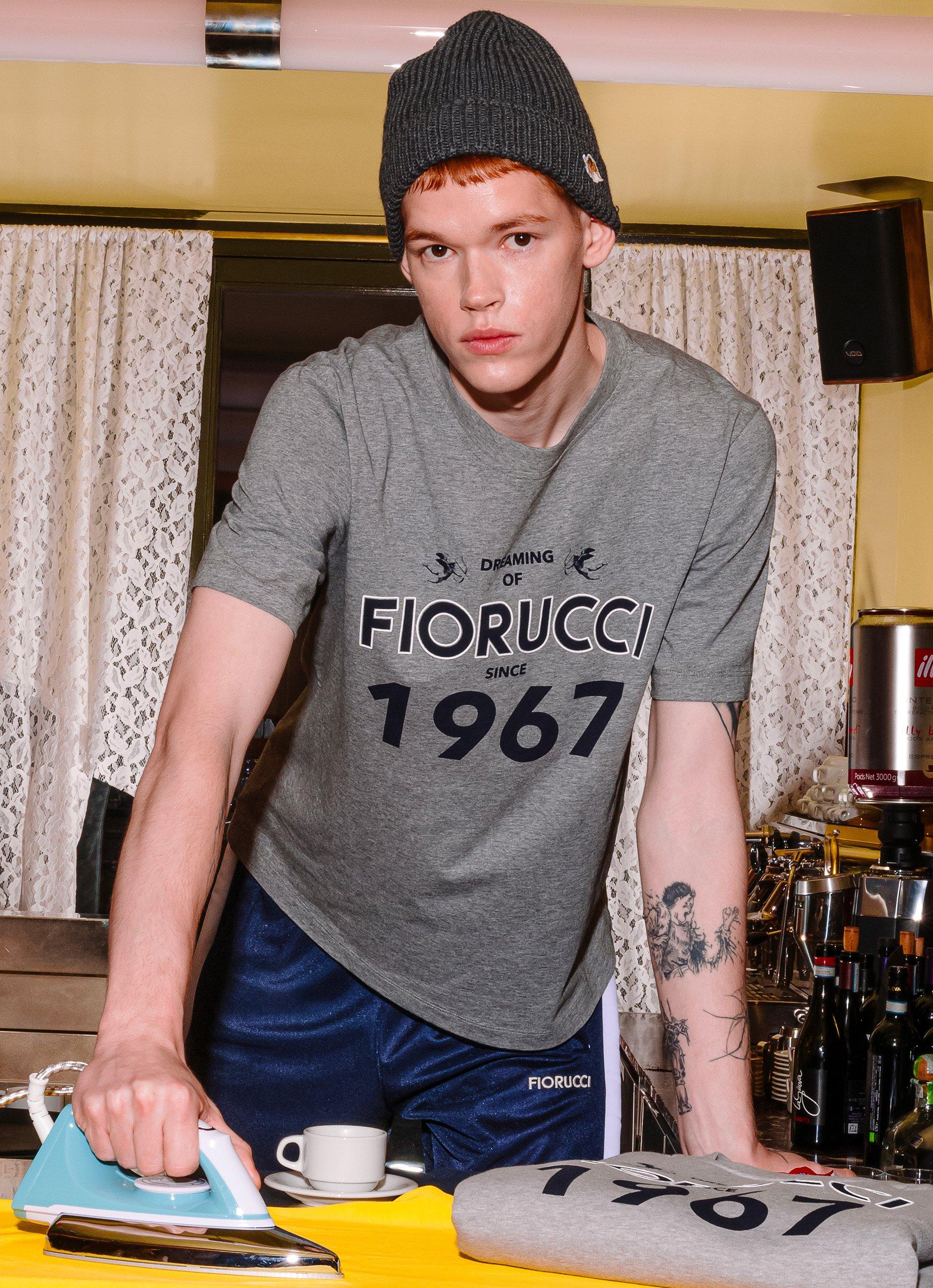 Model wears the Dreaming 1967 T-Shirt in Grey.