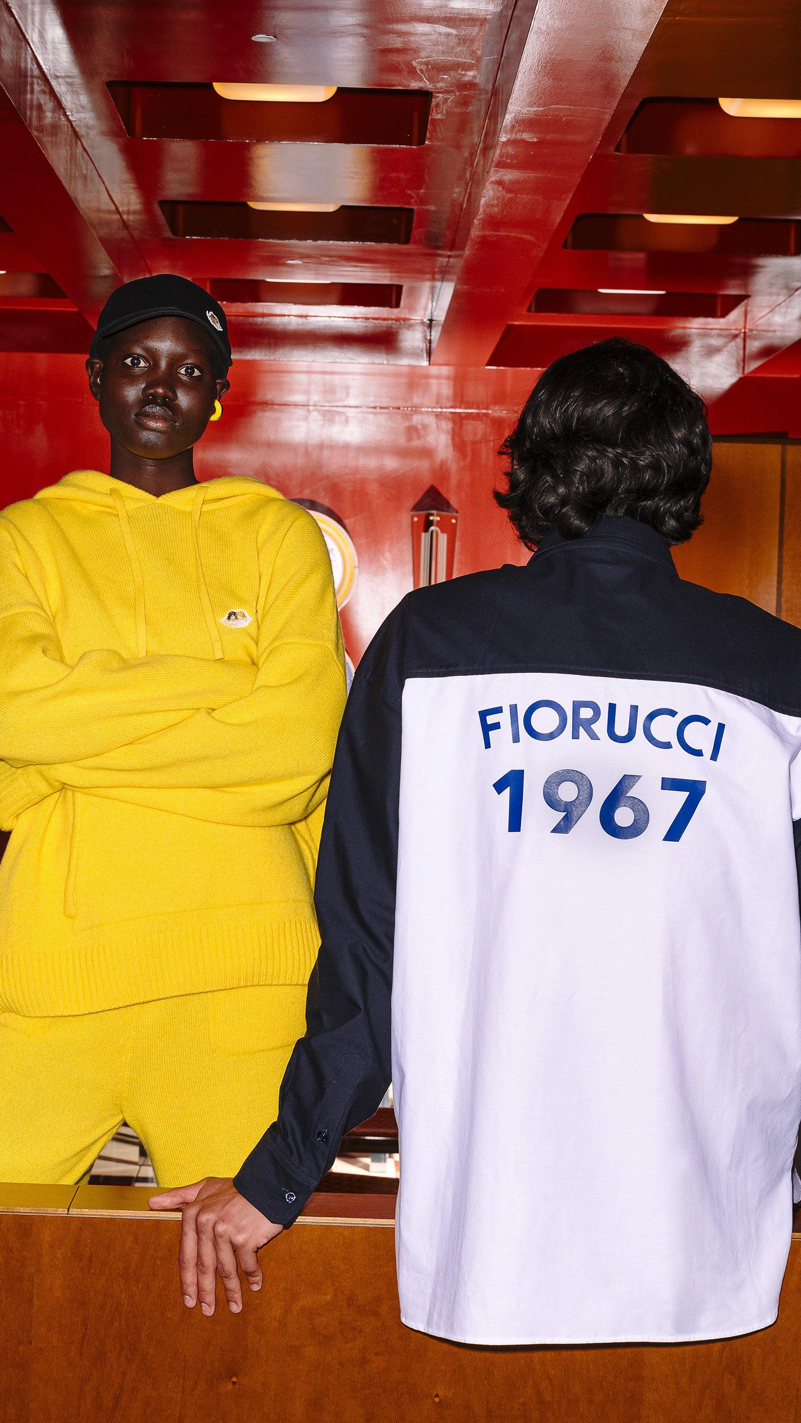 Models wear the Angels Patch Knit Hoodie in yellow and the 1967 Logo Shirt in navy.