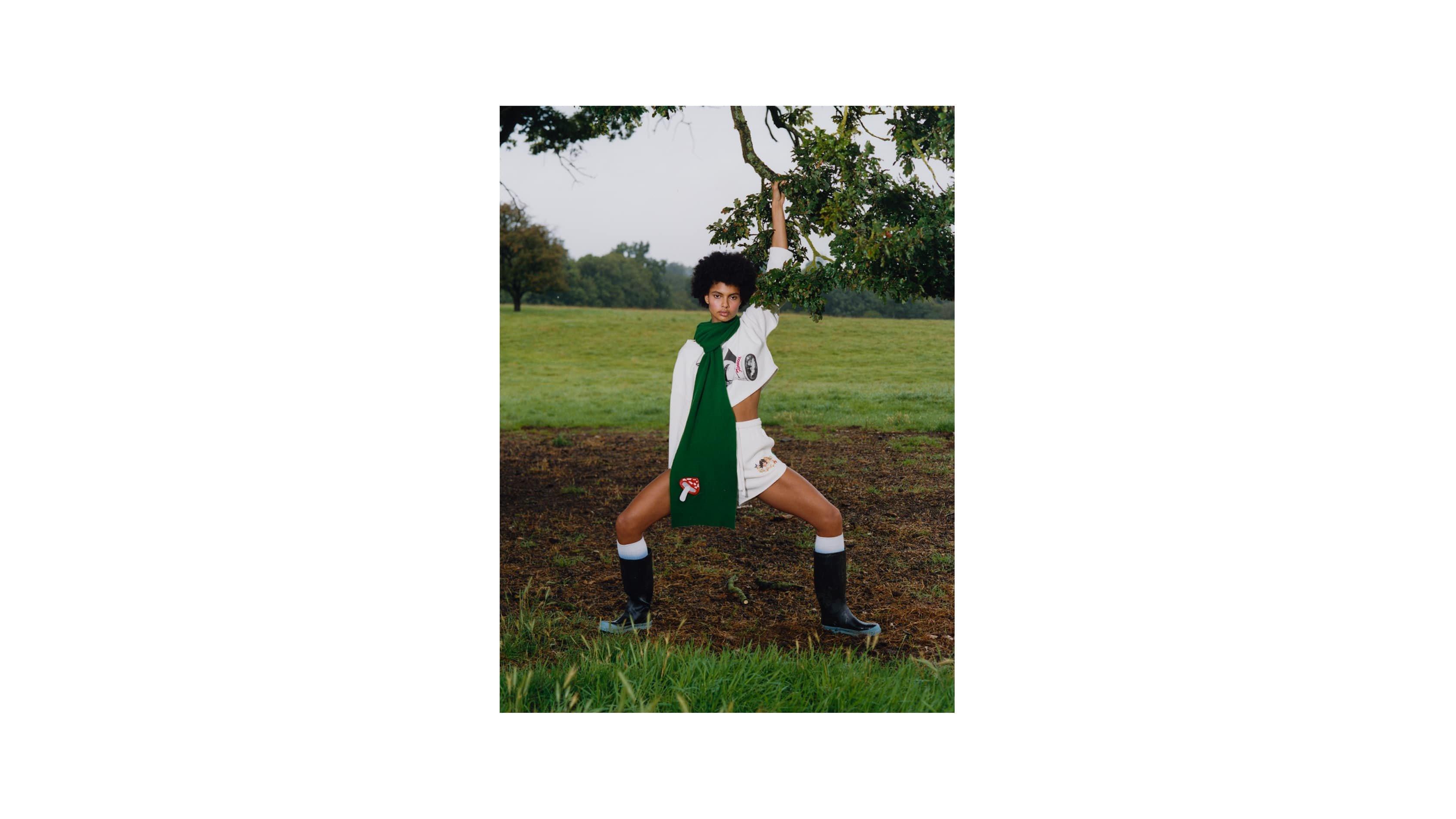 Model wearing the Woodland Angels Track Shorts in Off White and the Woodland Mushroom Patch Scarf in Green