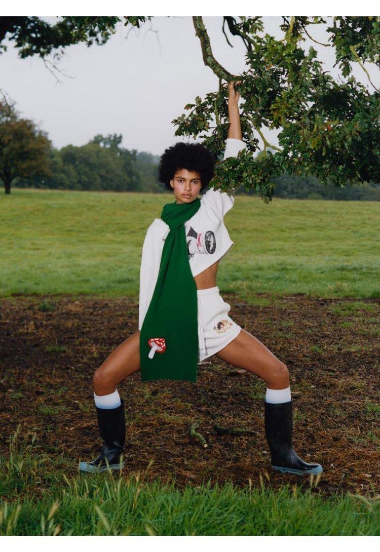 Model wearing the Woodland Angels Track Shorts in Off White and the Woodland Mushroom Patch Scarf in Green