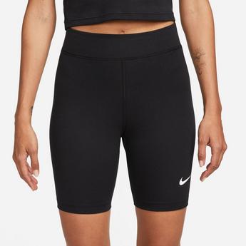 Nike with a simple black sweater slit open at the sides and leather culottes