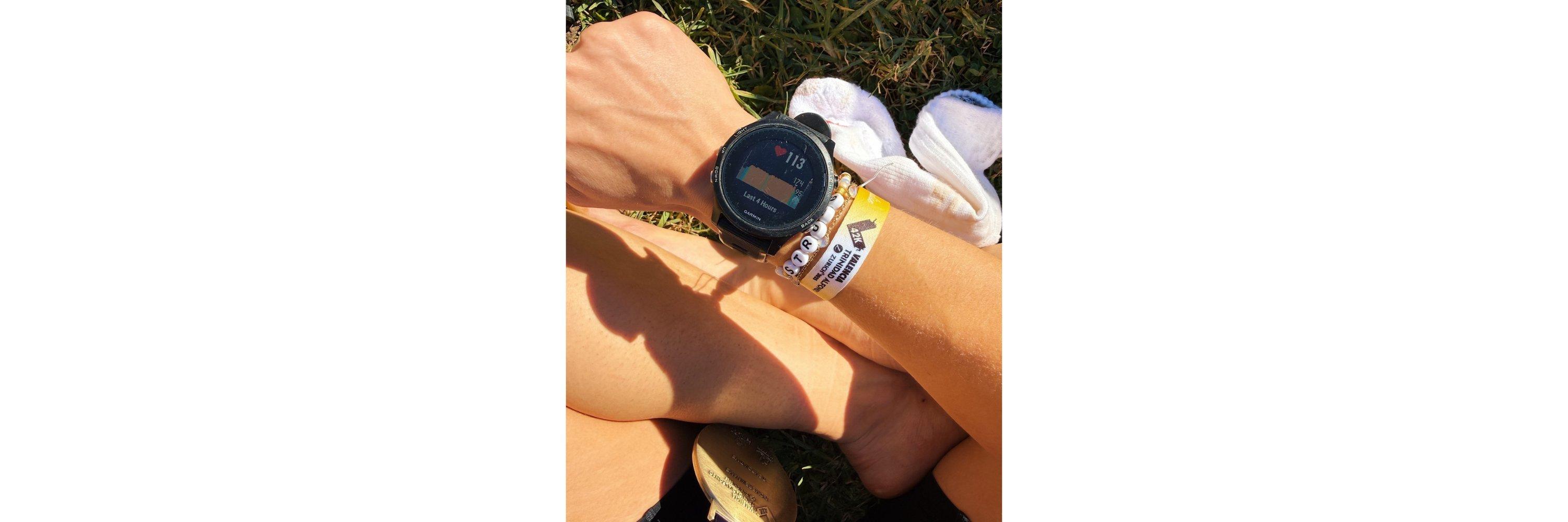 A photograph focusing on the wrist of someone wearing a running watch with heartrate displayed