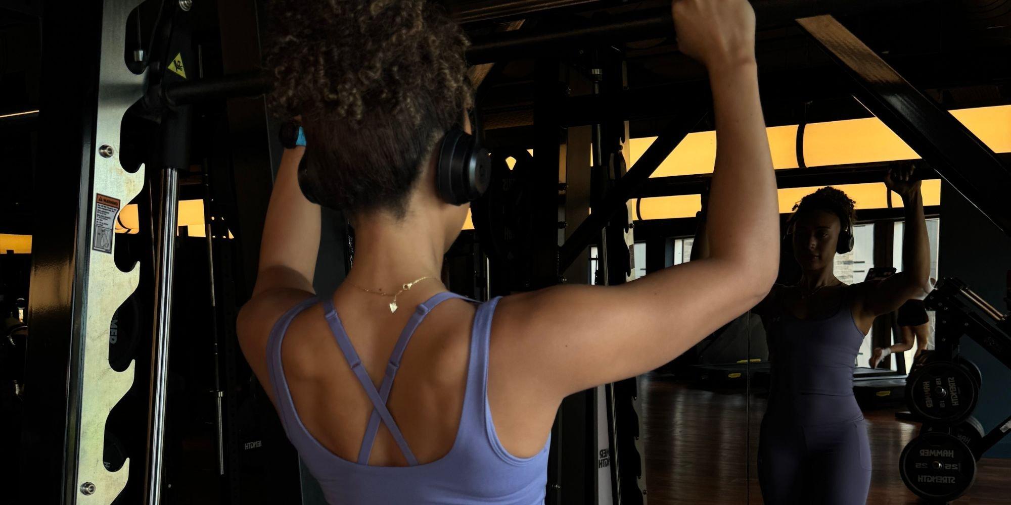 Edina performing a workout with her back to the camera