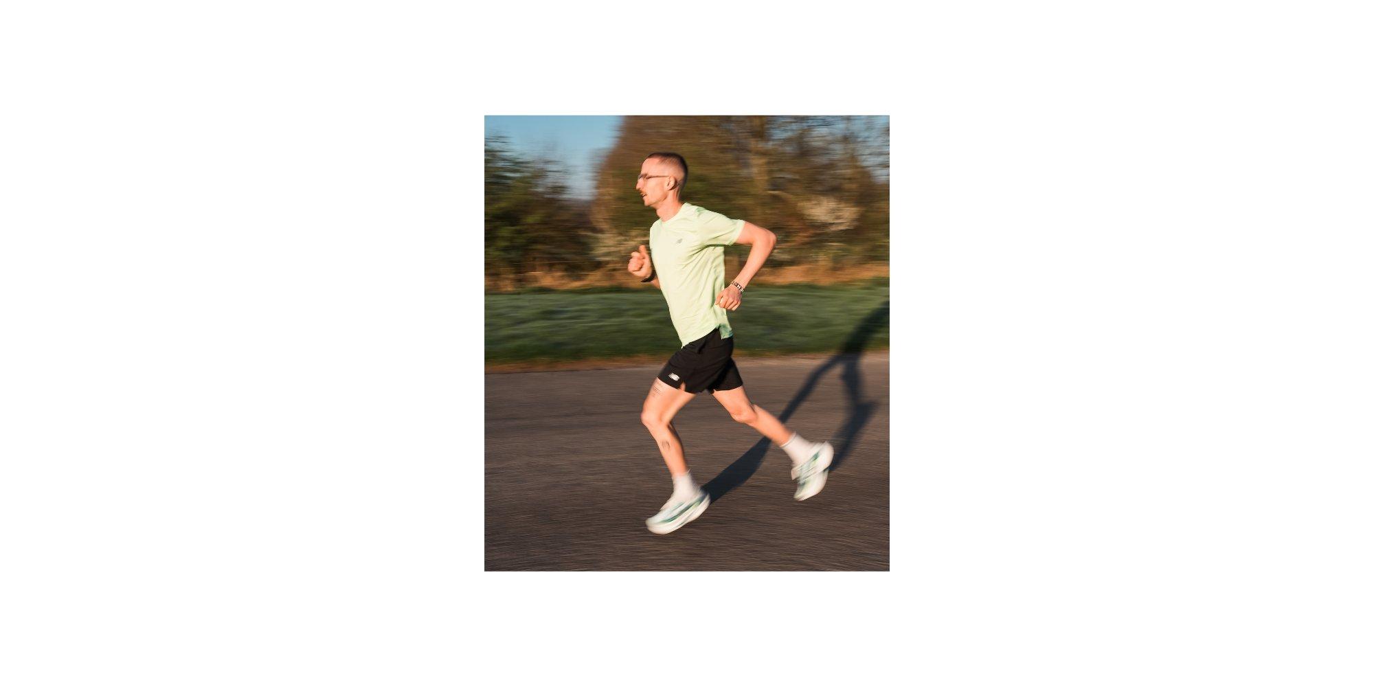 Image of a man dressed in running gear running on a road