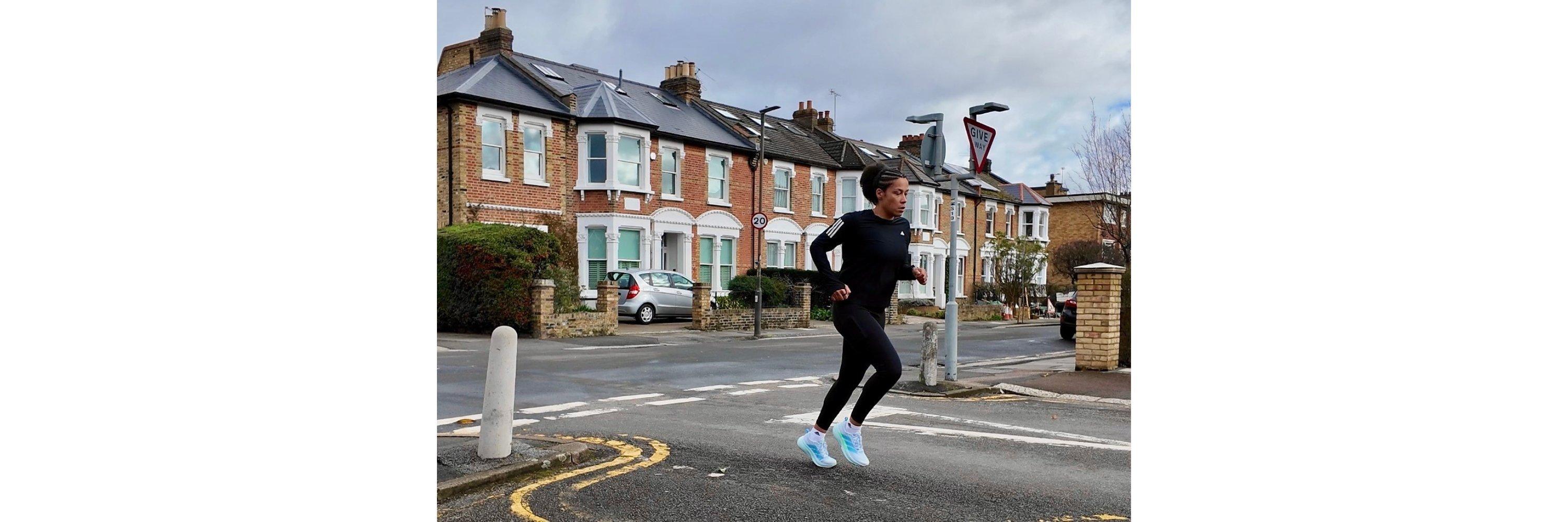 An image of a women wearing running gear in a suburban area 