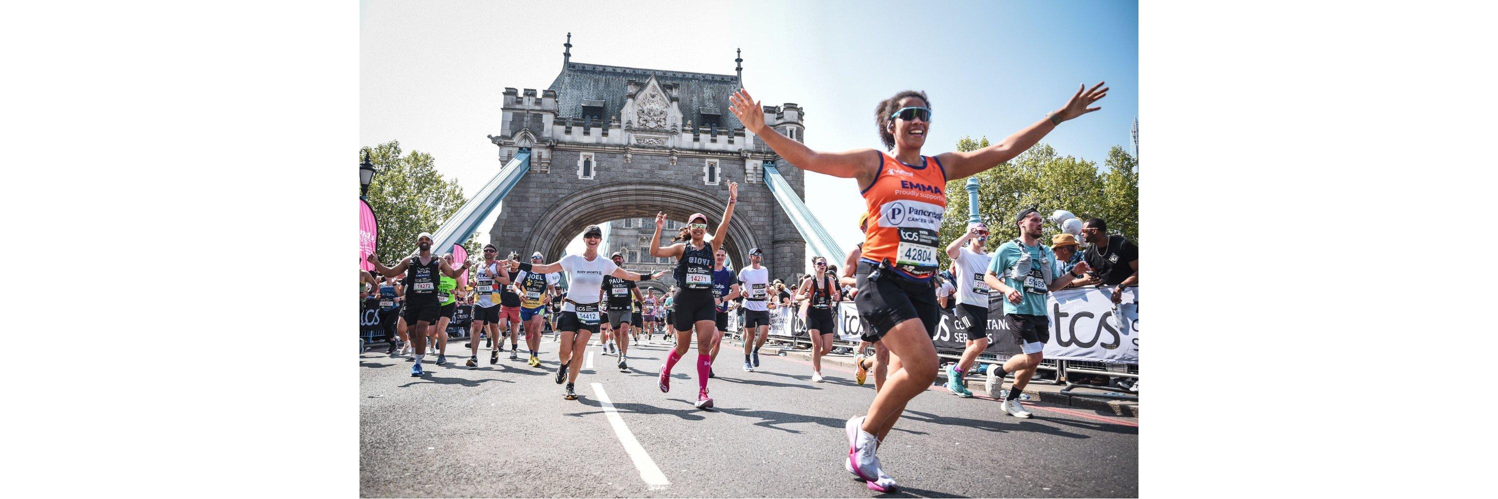 Woman in running gear celebrating whilst running in the london marathon
