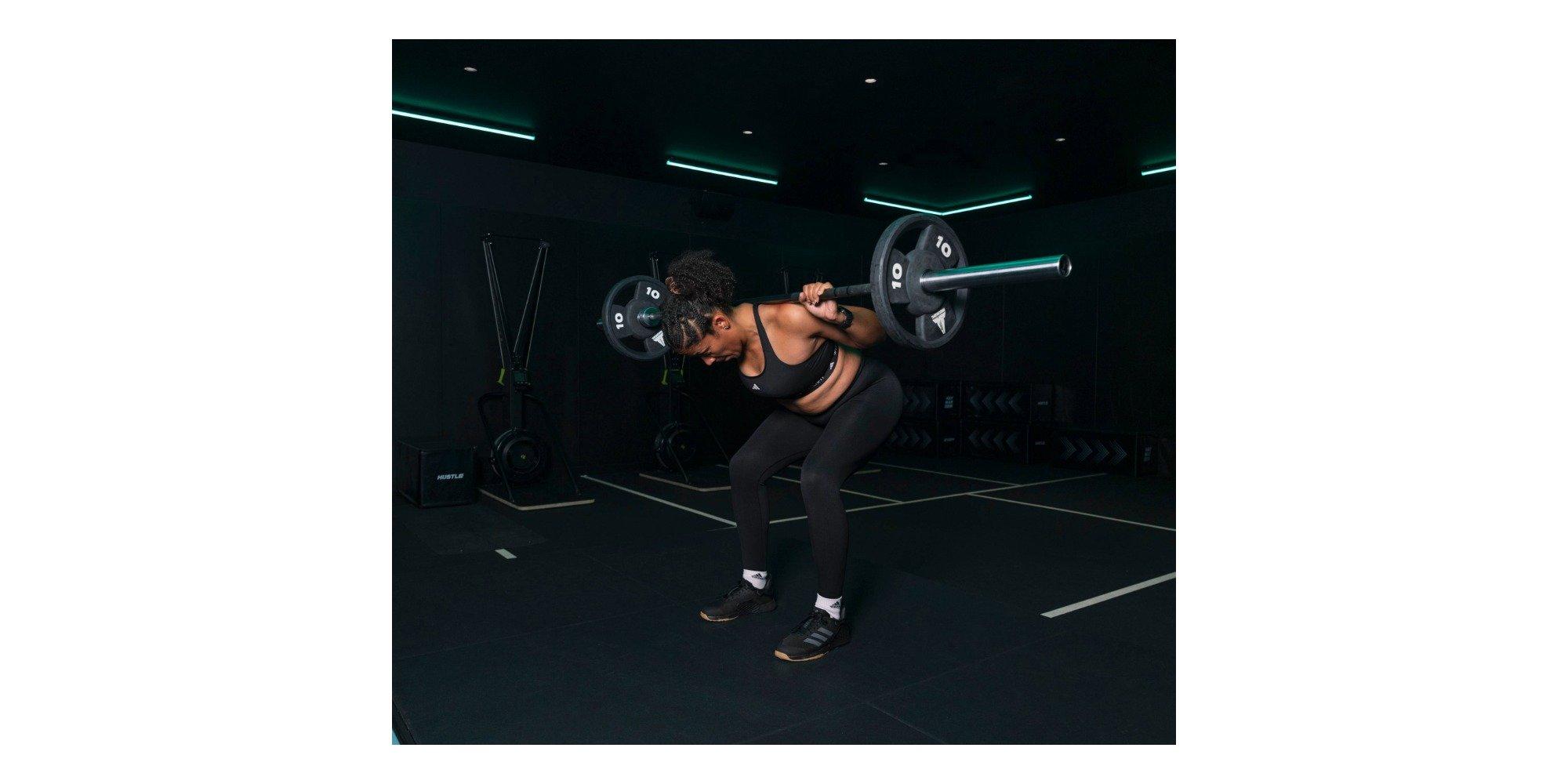 Emma doing a squat with a dumbbell